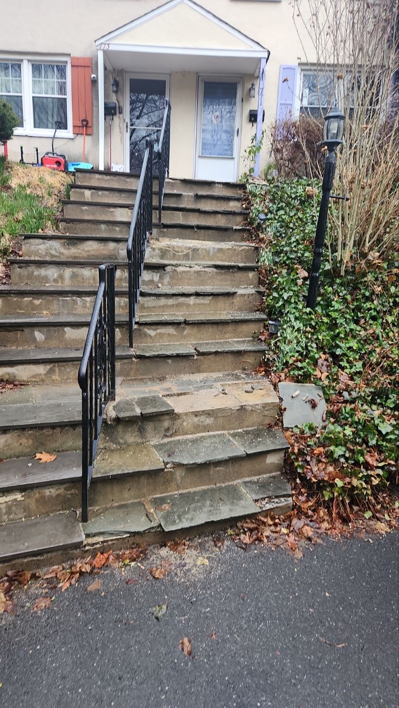 Cracked and uneven walkway in need of masonry repair